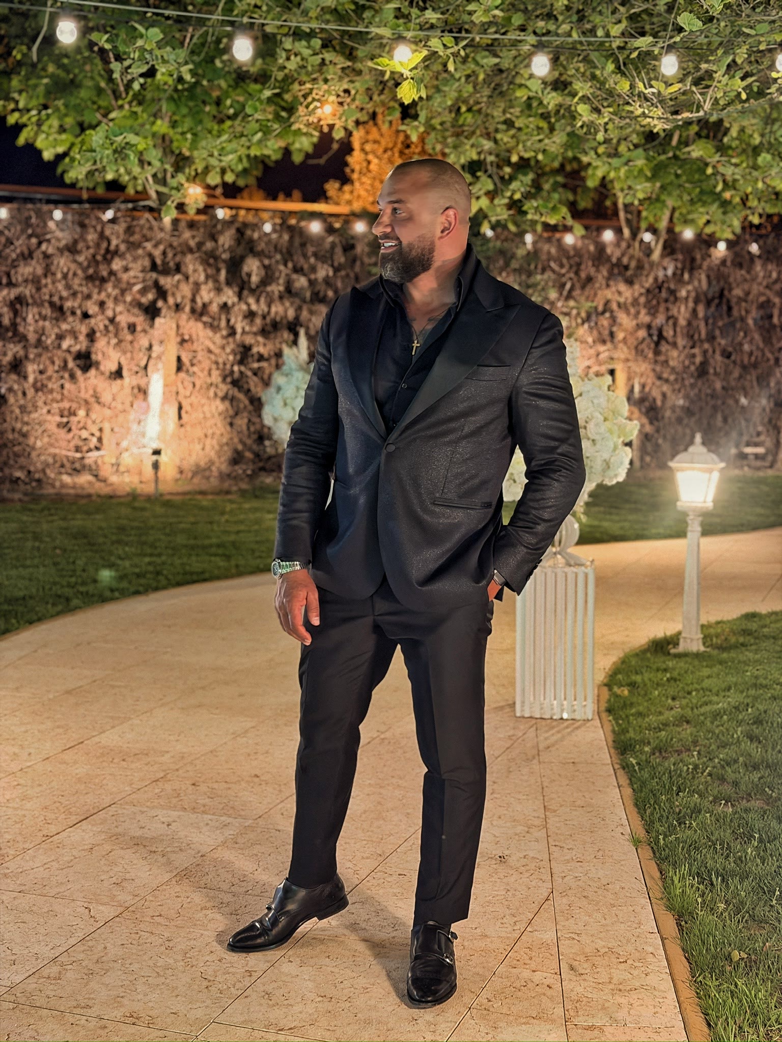 Alex Bodi in a black suit at an evening event