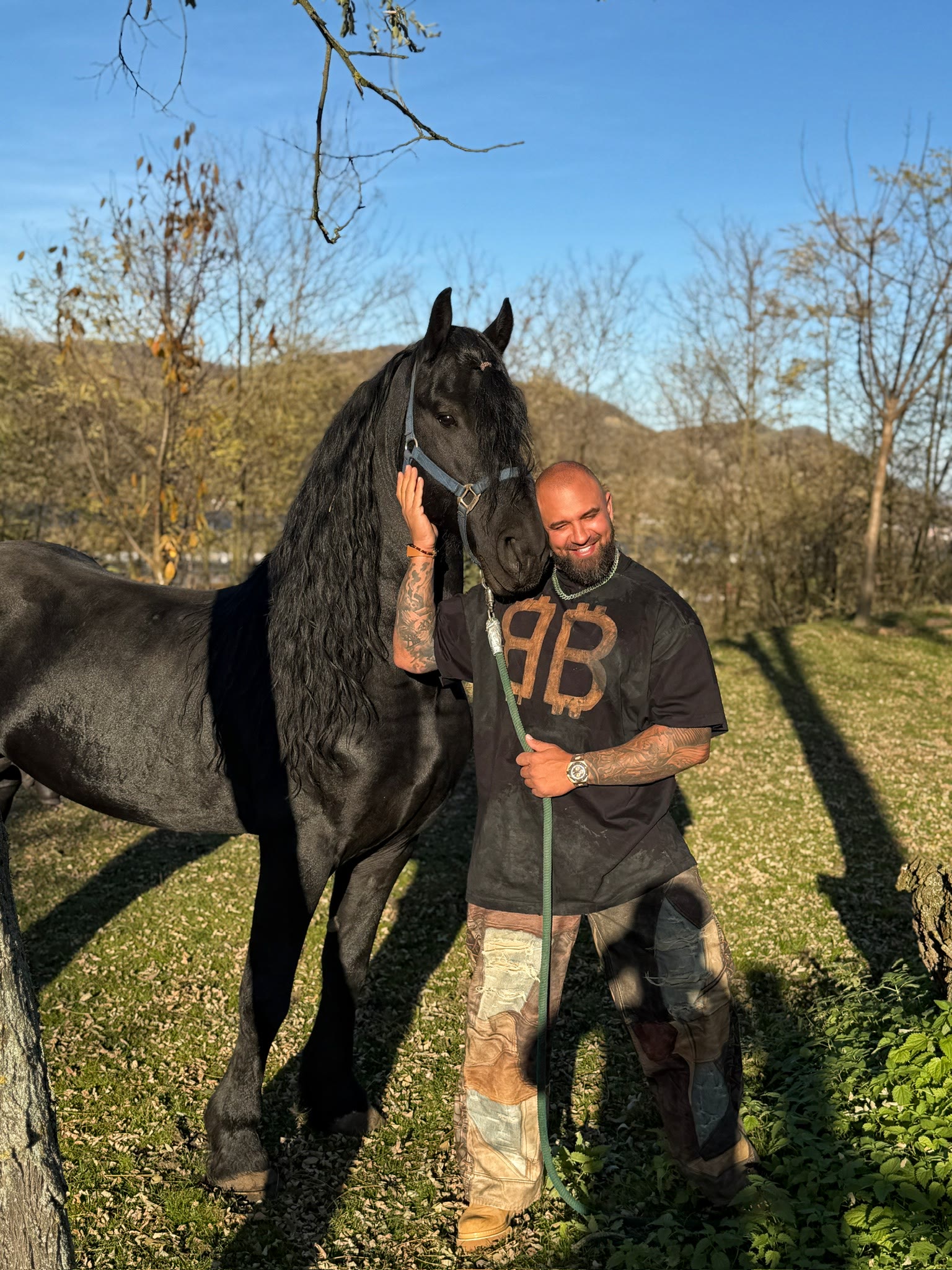 Alex Bodi standing with a black horse